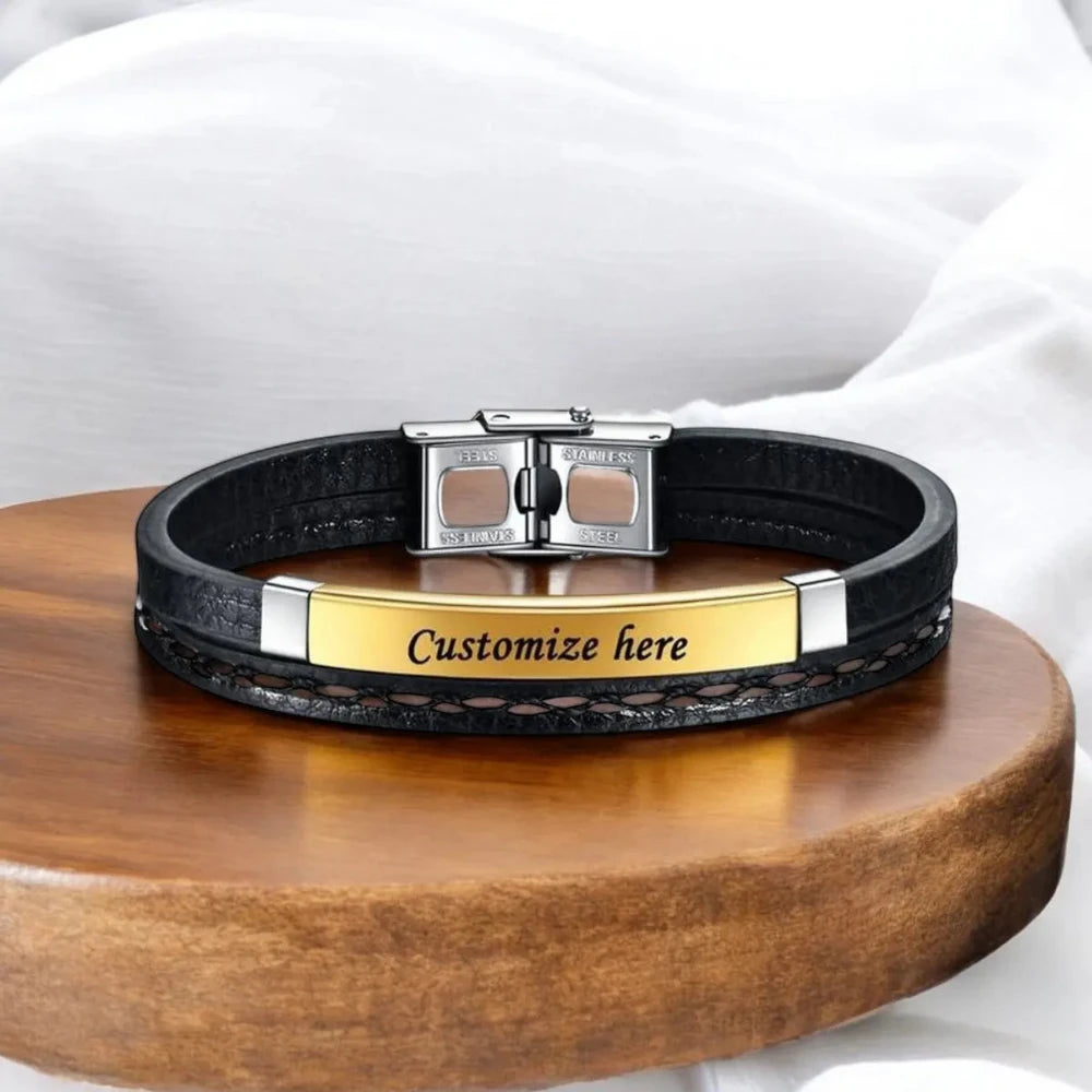 Side view of a Gold stainless steel and leather bracelet with buckle lock.